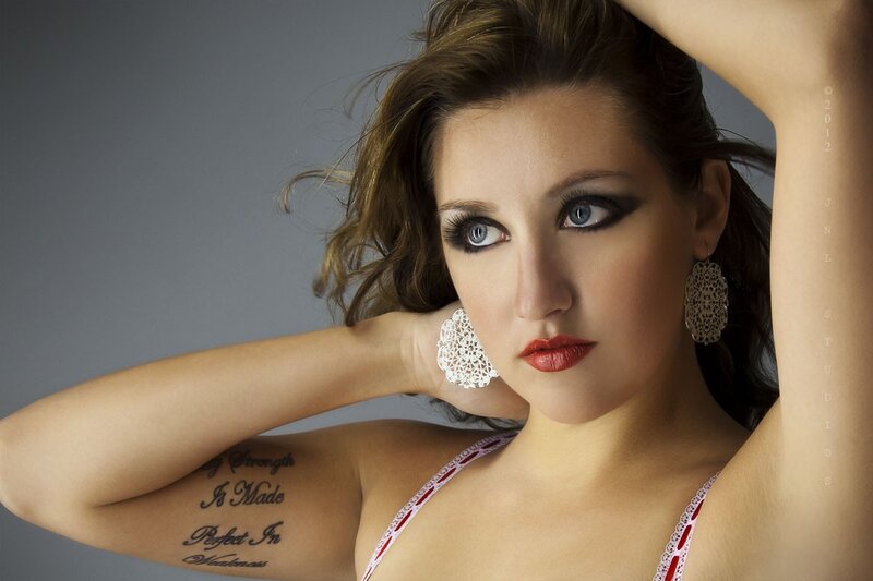 woman with tattoos and lace earrings