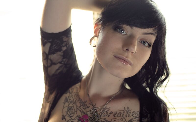 woman with tattoos and lace