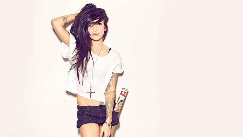 woman with tattoos and magazine