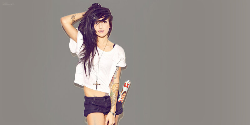 woman with tattoos and magazine
