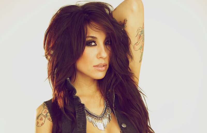 woman with tattoos and necklace