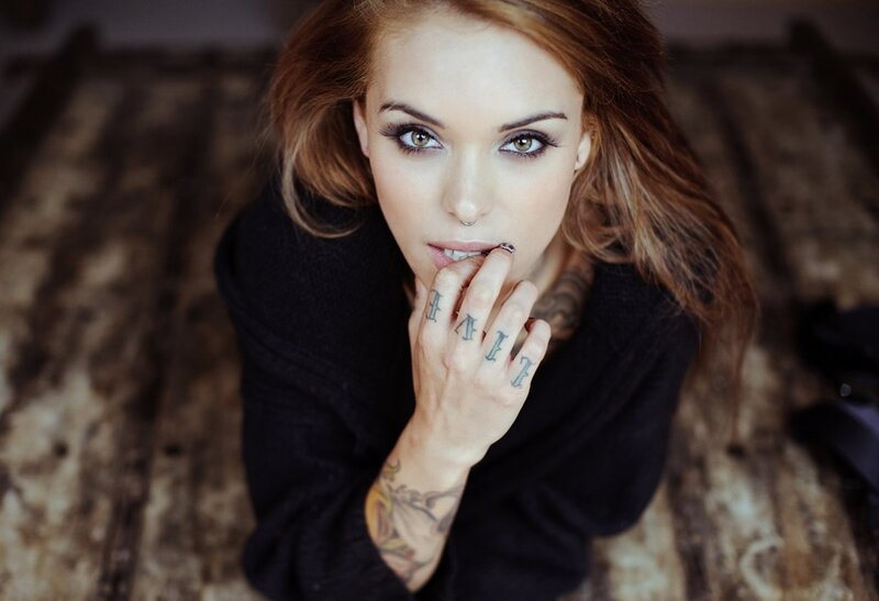 woman with tattoos and nose ring