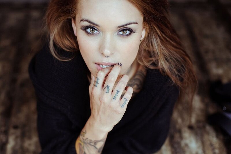 woman with tattoos and nose ring