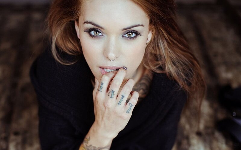 woman with tattoos and nose ring