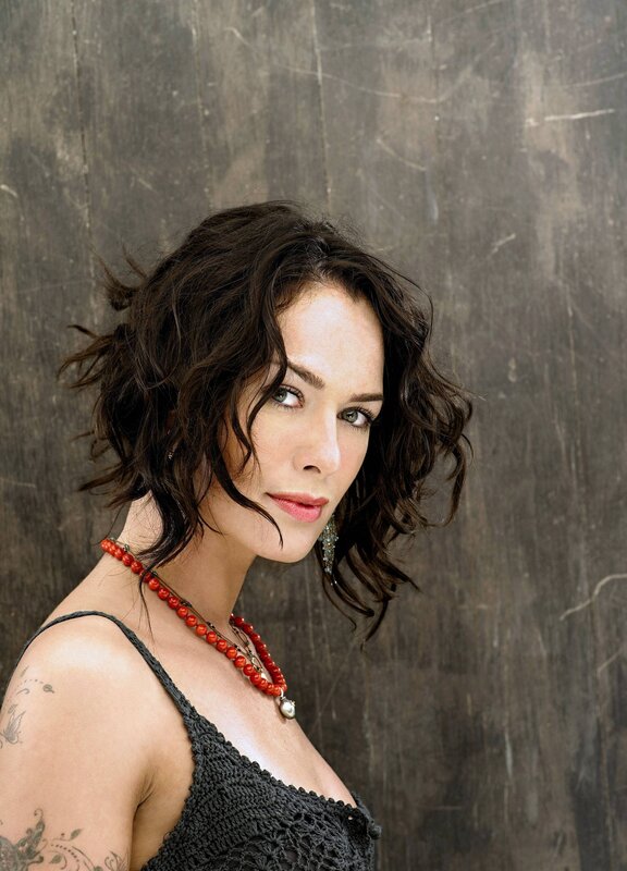 woman with tattoos and red necklace