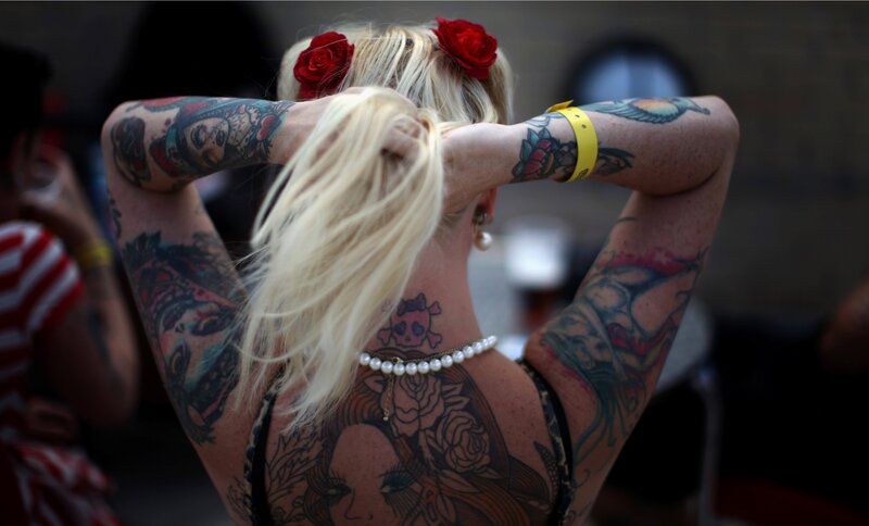 woman with tattoos and red roses