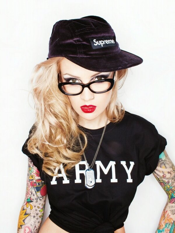woman with tattoos and supreme hat