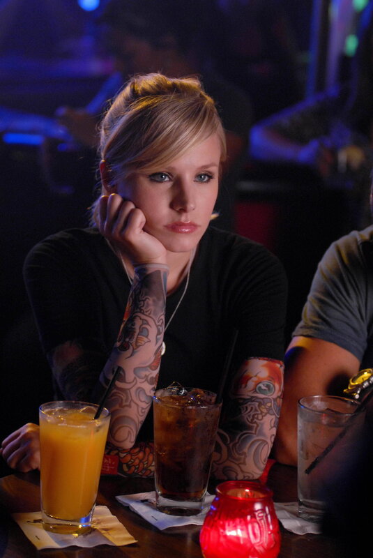 woman with tattoos at bar