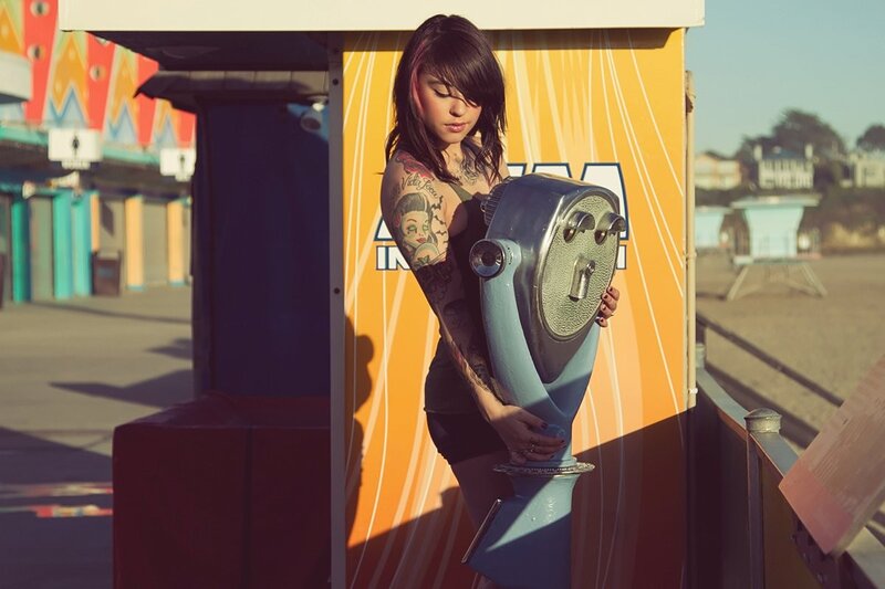 woman with tattoos at binoculars