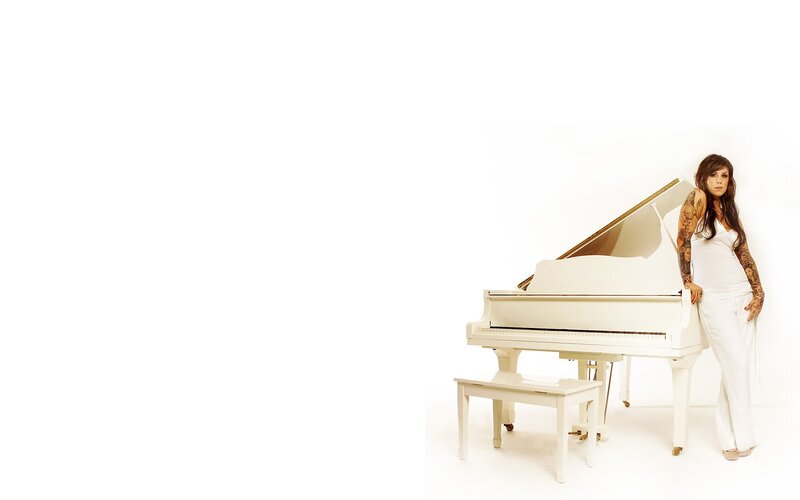 woman with tattoos at piano