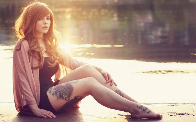 woman with tattoos at sunset