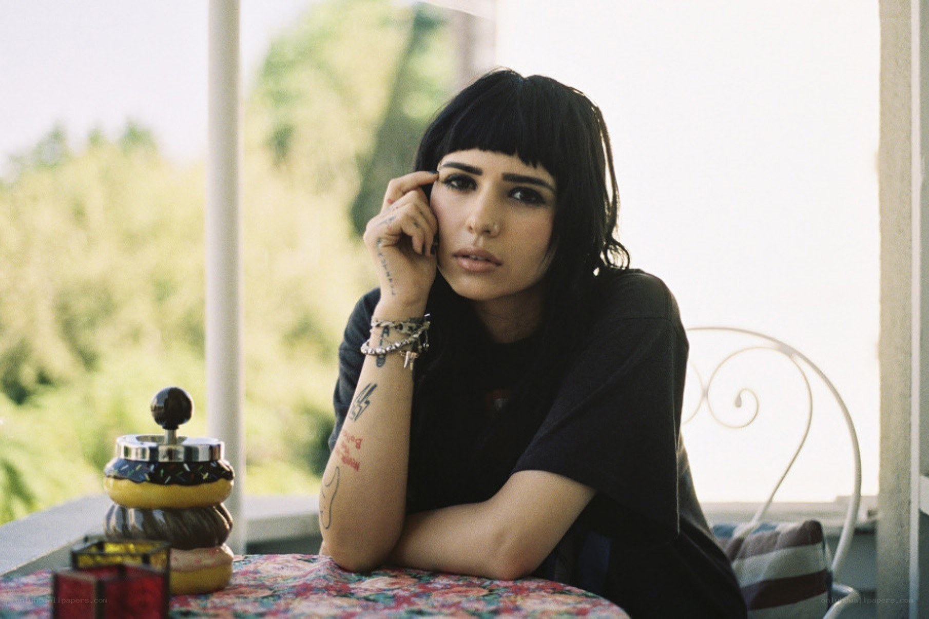 woman with tattoos at table