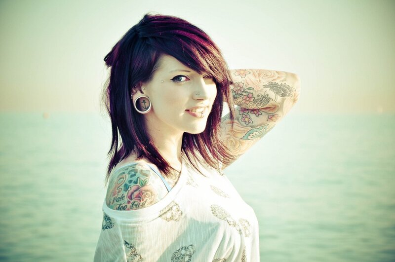 woman with tattoos at the beach