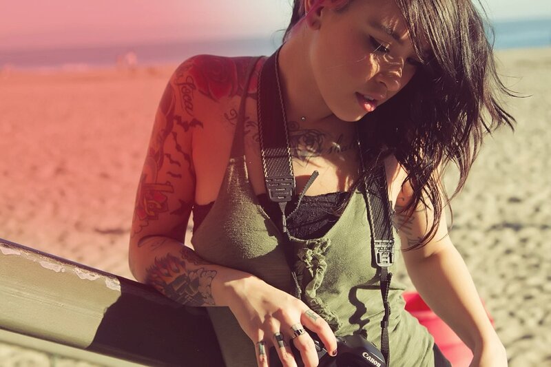 woman with tattoos at the beach