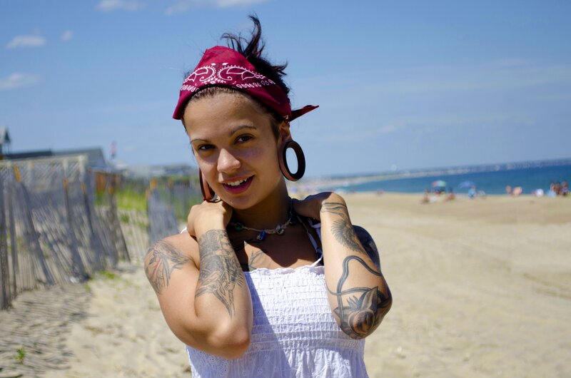 Woman with tattoos at the beach