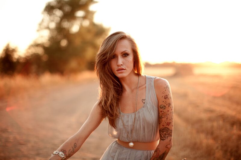 Woman with Tattoos — Brown, Dramatic, Sunset, Photograph, Dress