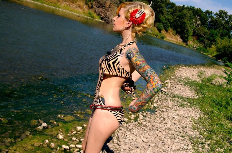 Woman with tattoos by a river