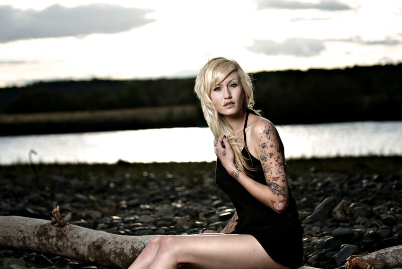 woman with tattoos by the river