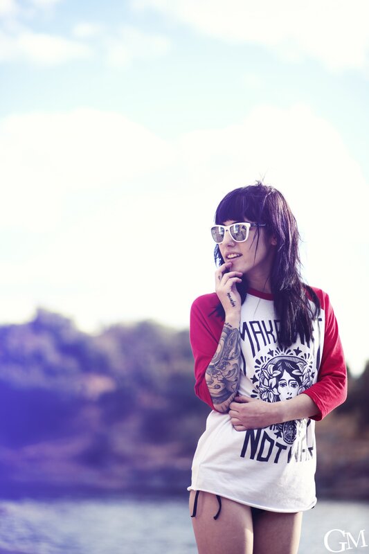 woman with tattoos by the water