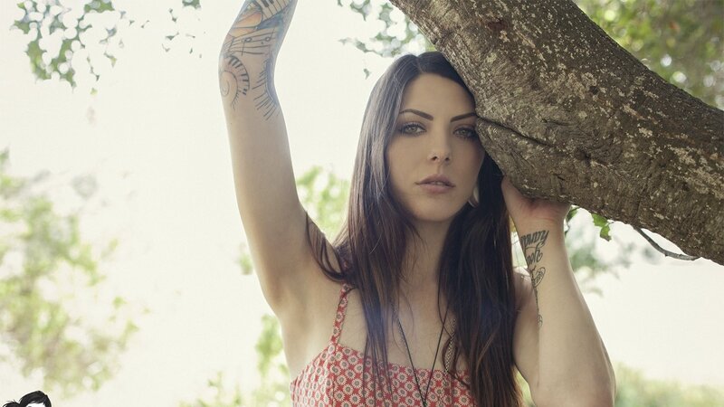 woman with tattoos by tree