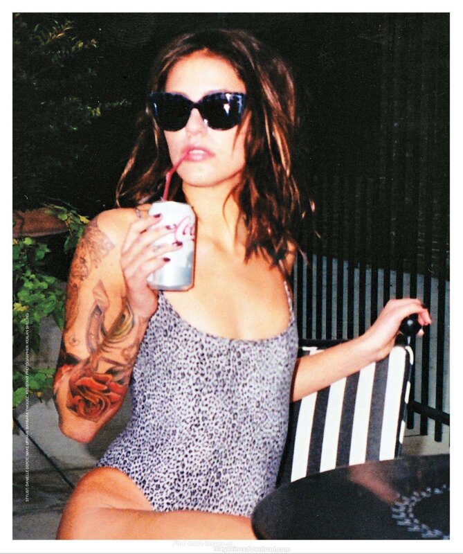 woman with tattoos drinking soda