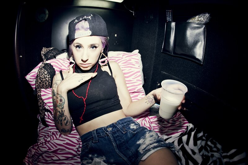 woman with tattoos in a car