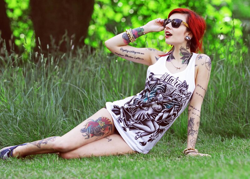 woman with tattoos in a park