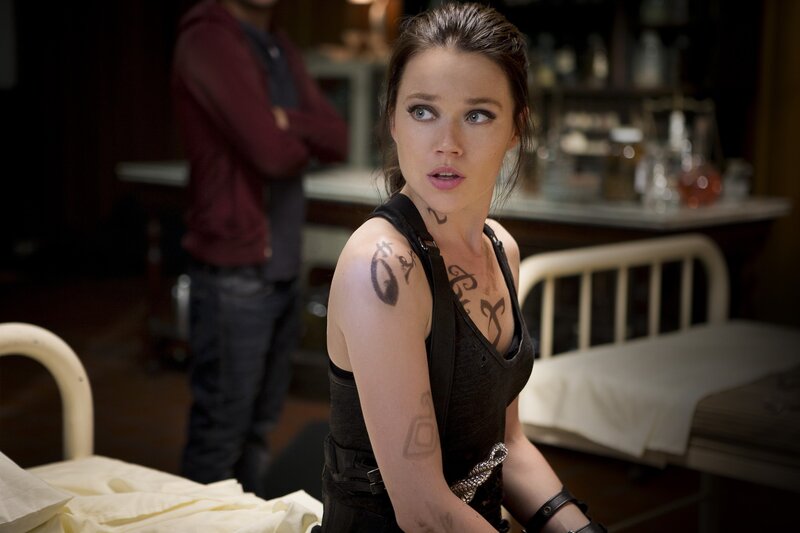 woman with tattoos in a room