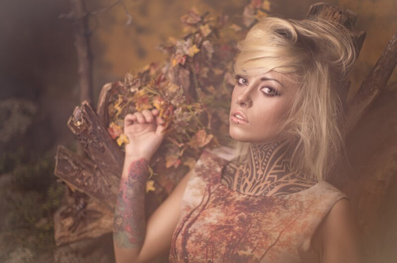woman with tattoos in autumn setting
