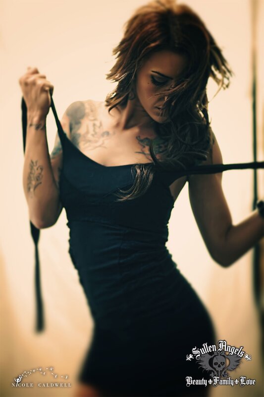 woman with tattoos in black dress
