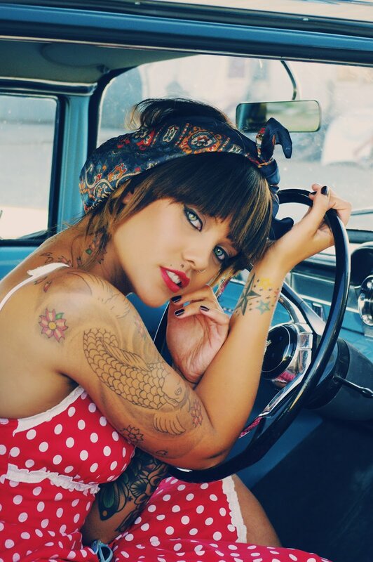 woman with tattoos in car
