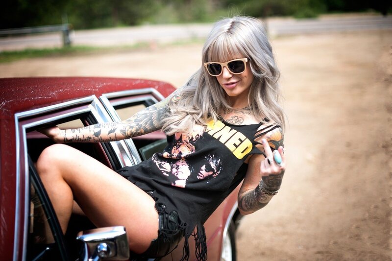 woman with tattoos in car
