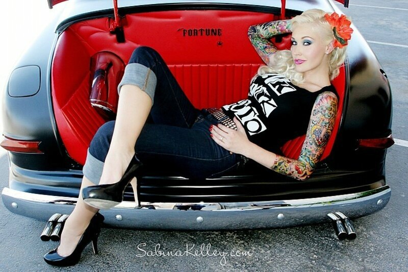 woman with tattoos in car trunk