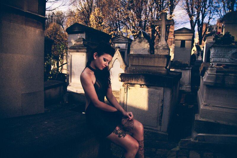 woman with tattoos in cemetery
