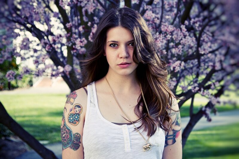 woman with tattoos in cherry blossom
