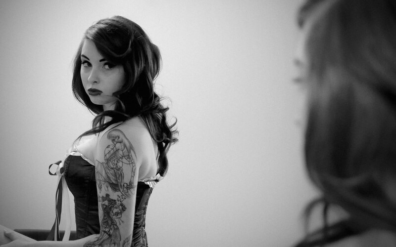 woman with tattoos in corset
