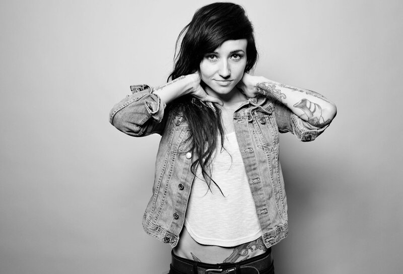 woman with tattoos in denim jacket