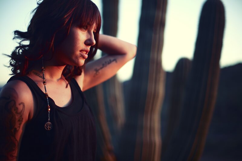 woman with tattoos in desert
