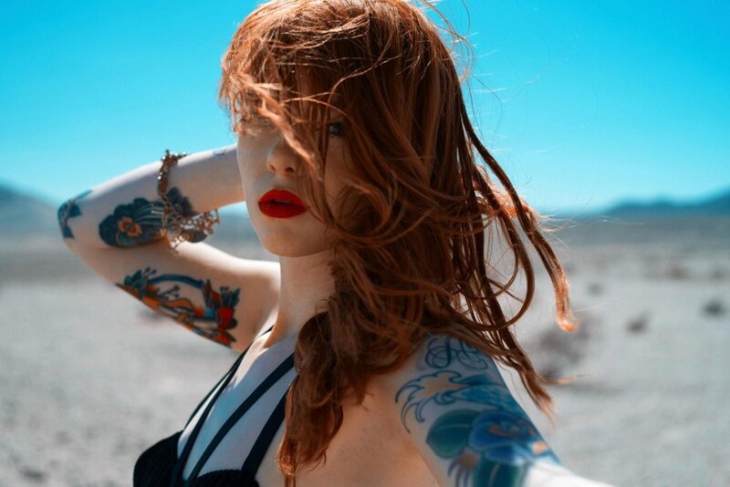 woman with tattoos in desert