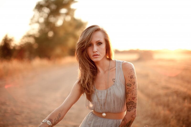 woman with tattoos in field