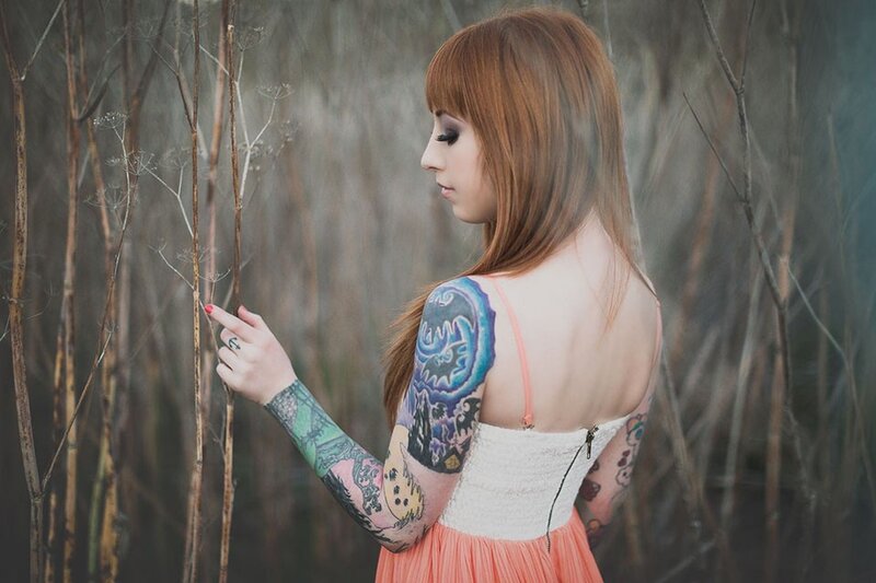 woman with tattoos in field