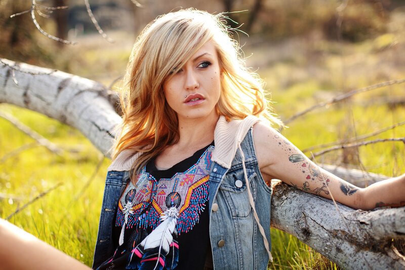 woman with tattoos in field