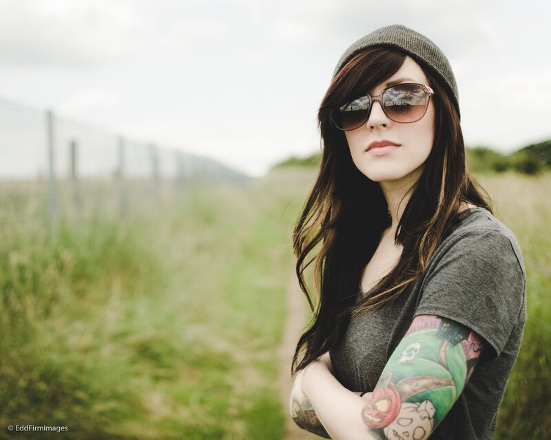 woman with tattoos in field