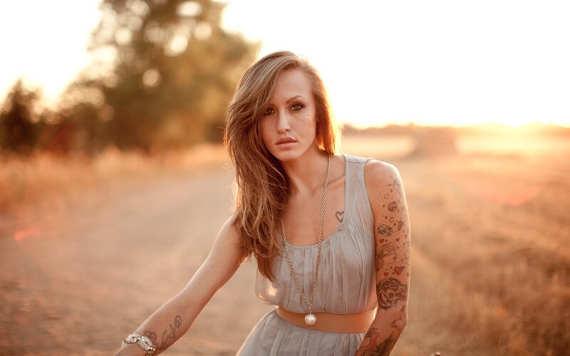 woman with tattoos in field