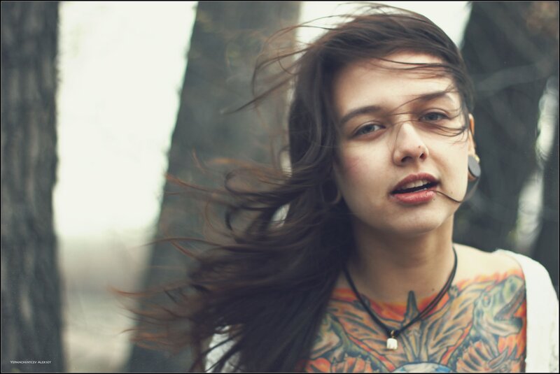 woman with tattoos in forest