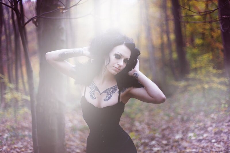 Woman with tattoos in forest