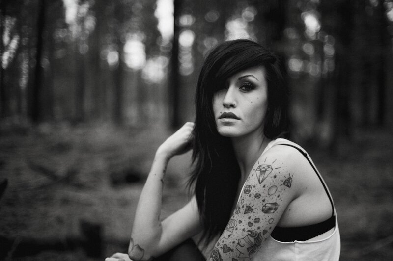 woman with tattoos in forest