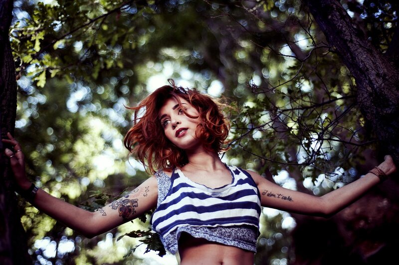 Woman with tattoos in forest