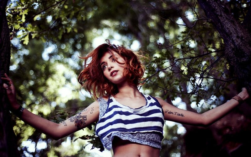 Woman with tattoos in forest