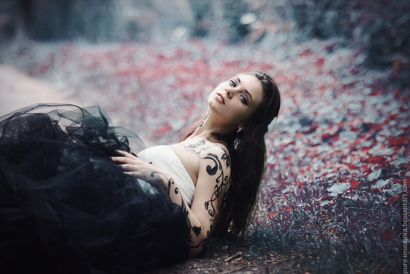 woman with tattoos in forest